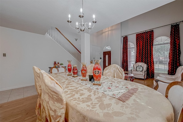 dining room with wood-type flooring and a notable chandelier