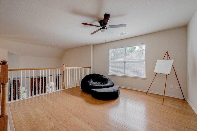 sitting room featuring vaulted ceiling, ceiling fan, and light hardwood / wood-style floors