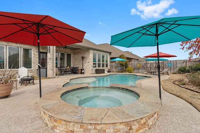 view of pool with an in ground hot tub and a patio area