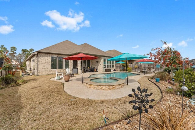 view of swimming pool featuring an in ground hot tub and a patio