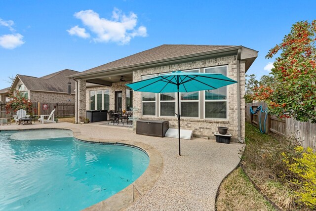 back of house with a fenced in pool, a patio area, and ceiling fan