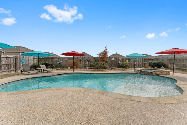 view of swimming pool featuring an in ground hot tub and a patio area