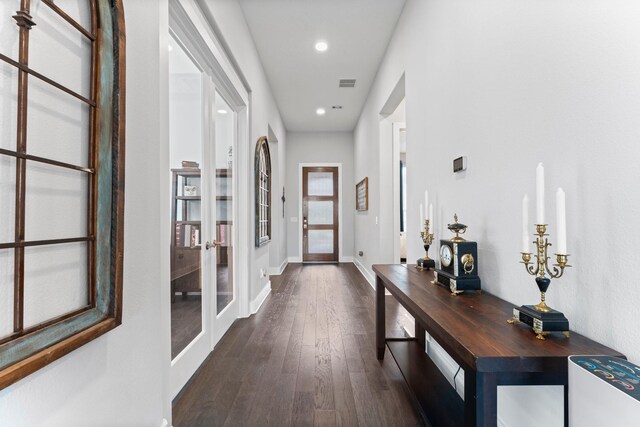 corridor featuring dark hardwood / wood-style flooring and french doors