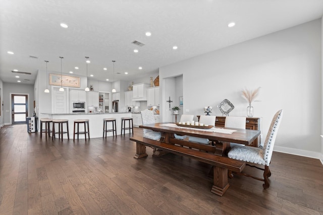 dining area featuring dark hardwood / wood-style flooring