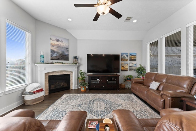 living room featuring dark wood-type flooring, vaulted ceiling, and ceiling fan