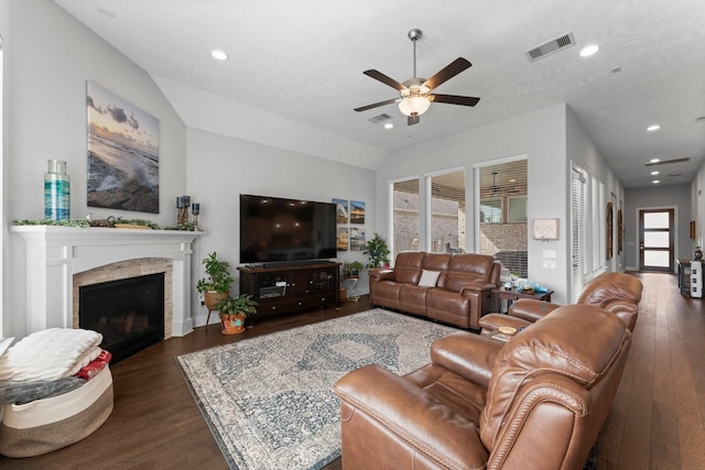 living room featuring vaulted ceiling, dark hardwood / wood-style floors, and ceiling fan