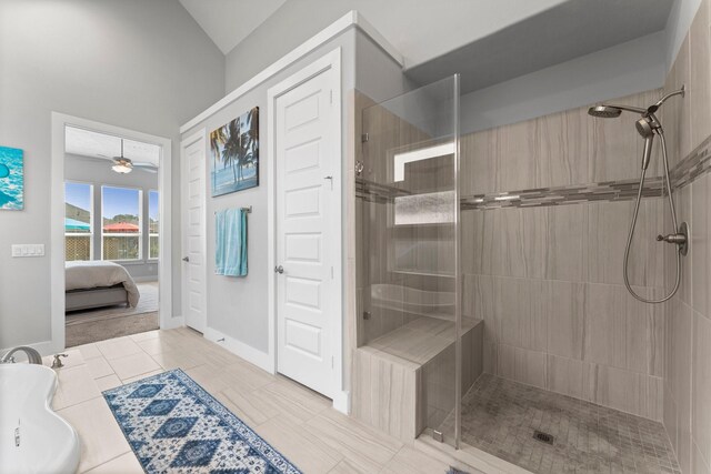 bathroom with tile patterned flooring, ceiling fan, and tiled shower