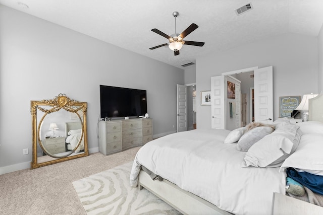 carpeted bedroom with lofted ceiling, a textured ceiling, and ceiling fan