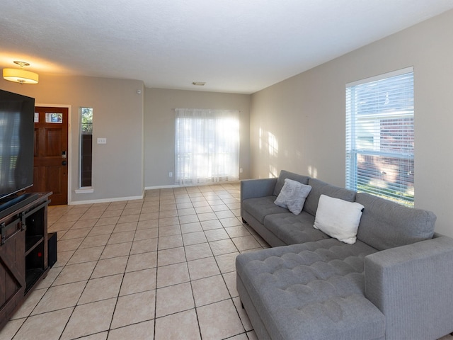 living room featuring light tile patterned floors and plenty of natural light