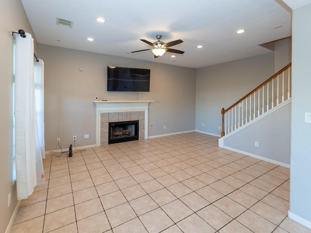 unfurnished living room with ceiling fan and a fireplace