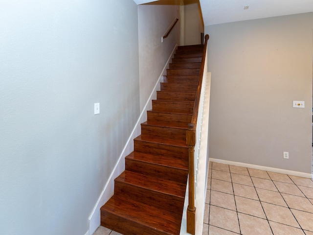 stairway with tile patterned floors