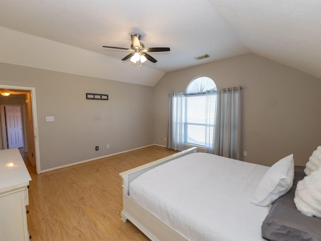 bedroom with vaulted ceiling, ceiling fan, and light wood-type flooring