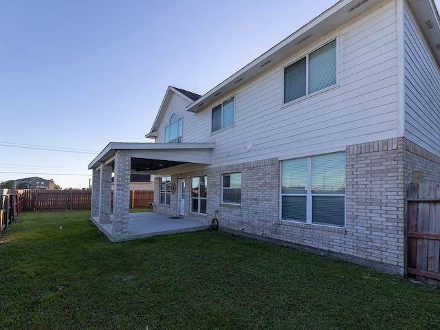 back of house featuring a yard and a patio area