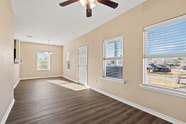 entryway with dark wood-type flooring and ceiling fan with notable chandelier