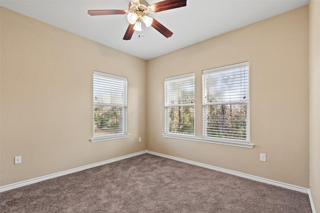 carpeted spare room with ceiling fan