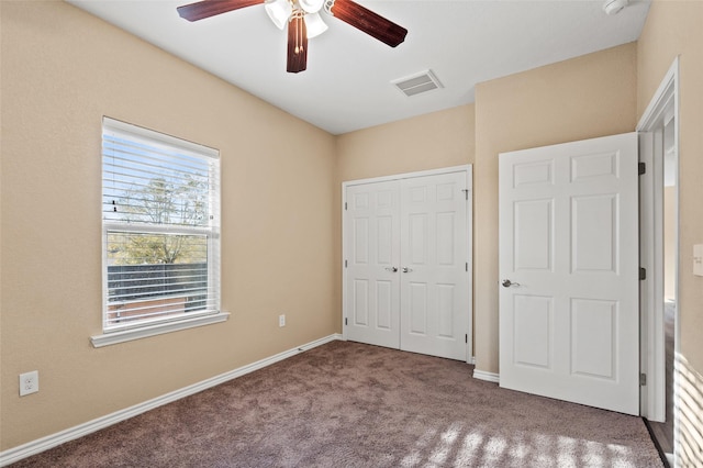 unfurnished bedroom featuring carpet flooring, ceiling fan, and a closet