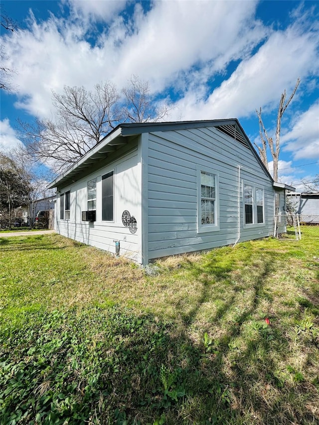 view of side of property with a lawn