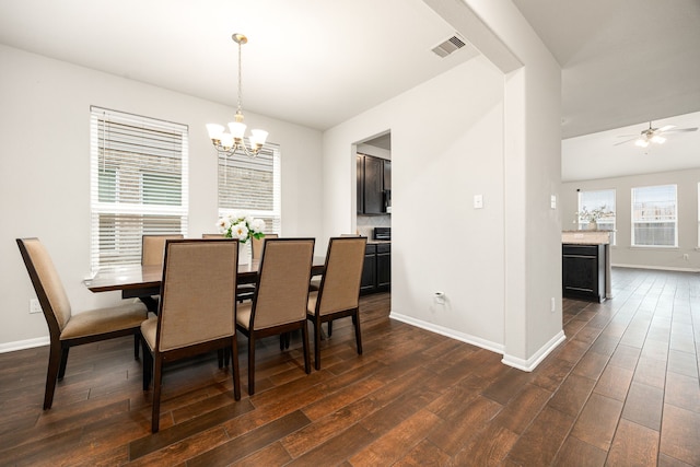 dining area featuring dark hardwood / wood-style floors and ceiling fan with notable chandelier