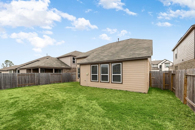 back of house with a lawn