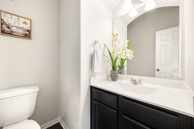 bathroom featuring vanity and toilet