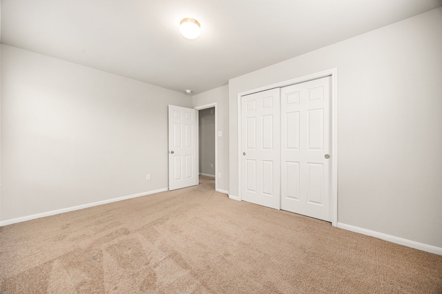 unfurnished bedroom featuring carpet floors and a closet