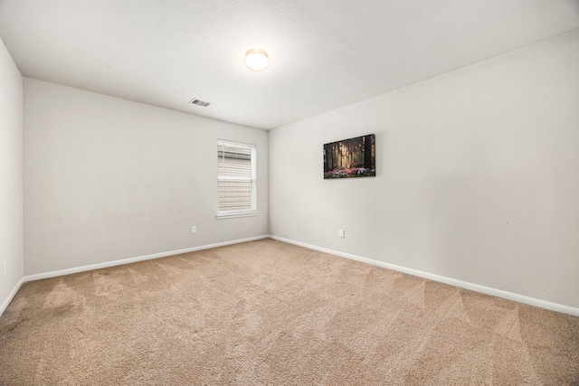 carpeted spare room with a textured ceiling