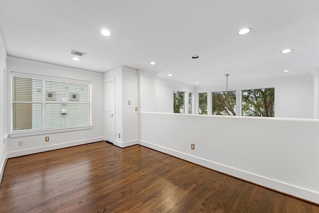 unfurnished room with ornamental molding and dark hardwood / wood-style floors