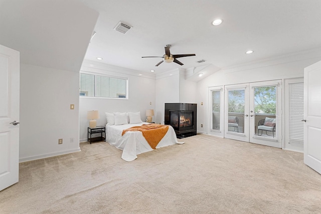 bedroom featuring light carpet, access to exterior, ceiling fan, and a multi sided fireplace