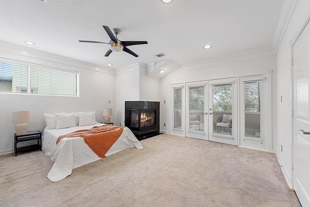 bedroom featuring multiple windows, ornamental molding, access to outside, and light colored carpet