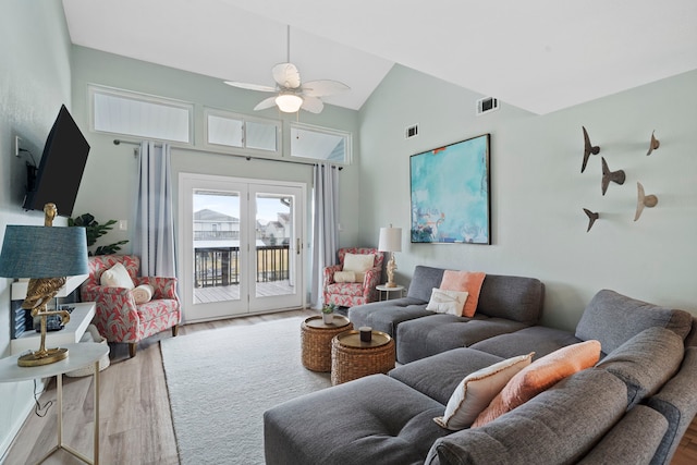 living room with ceiling fan, wood-type flooring, and high vaulted ceiling