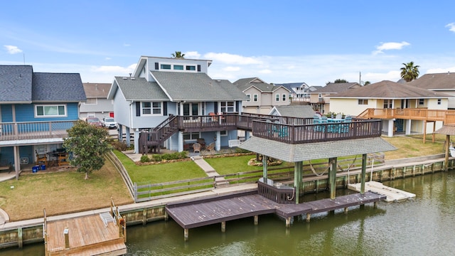 back of house featuring a deck with water view and a yard