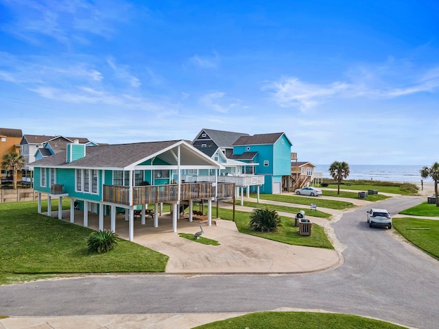 view of property's community featuring a water view and a lawn