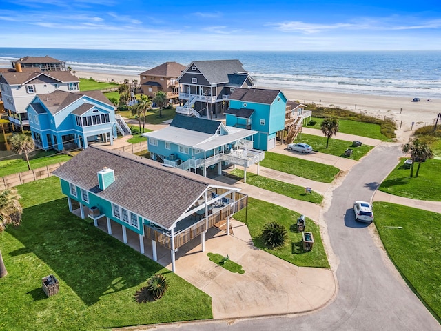 drone / aerial view with a beach view and a water view