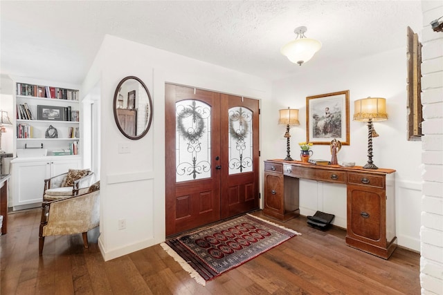 entrance foyer with hardwood / wood-style flooring, french doors, and a textured ceiling