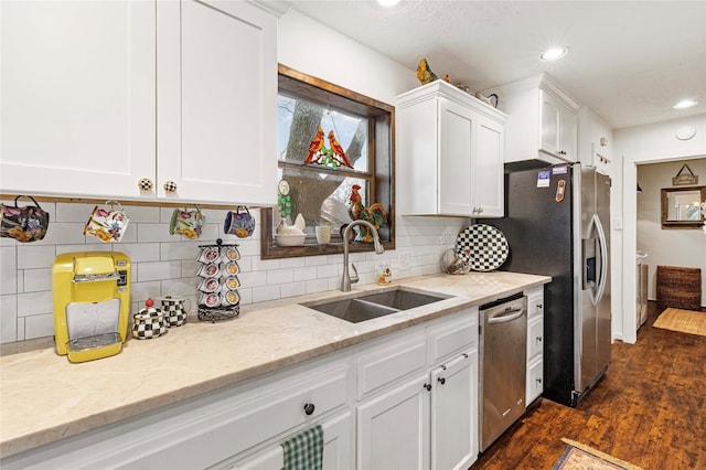 kitchen featuring dark wood-type flooring, sink, stainless steel appliances, light stone countertops, and white cabinets