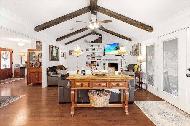 interior space with ceiling fan, a fireplace, dark hardwood / wood-style floors, and lofted ceiling with beams