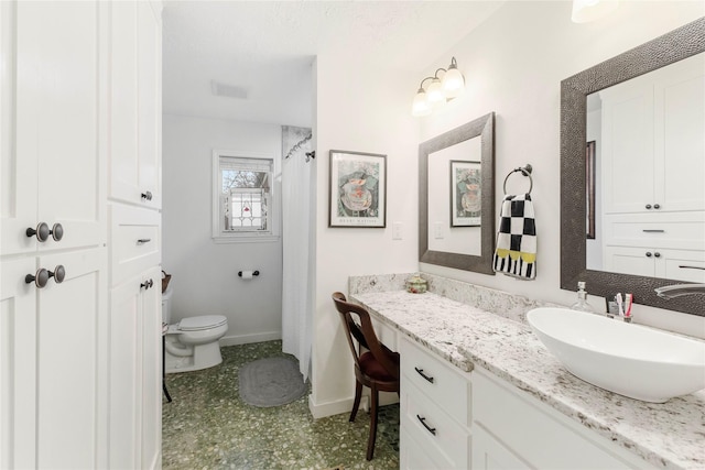 bathroom with vanity, a shower with shower curtain, and toilet