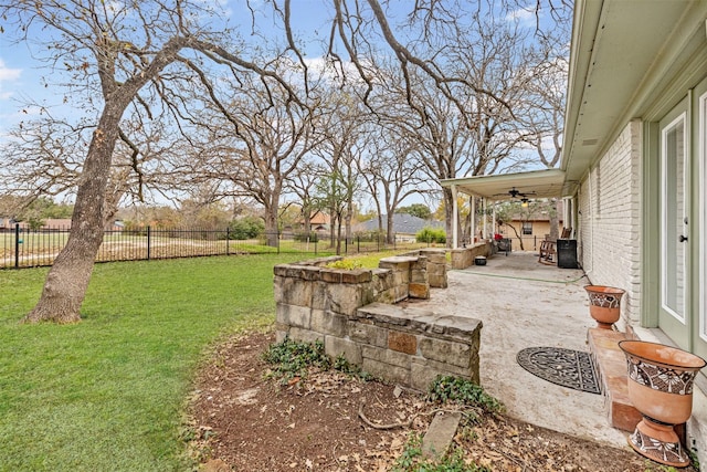 view of yard featuring a patio and ceiling fan