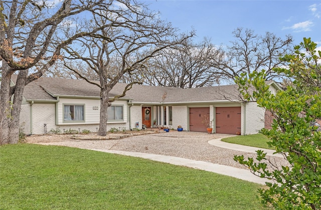 single story home featuring a garage and a front yard