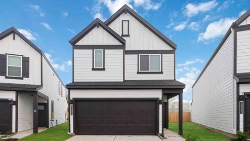 modern farmhouse with a garage and a front yard