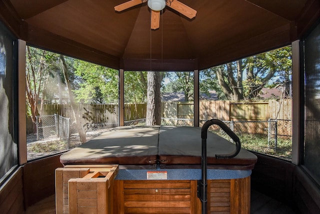 sunroom with ceiling fan and vaulted ceiling