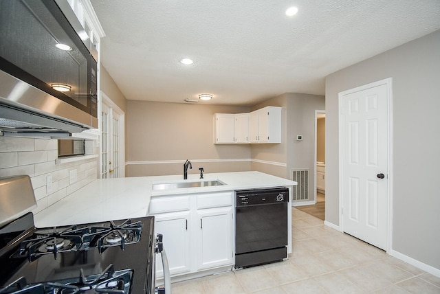 kitchen featuring tasteful backsplash, appliances with stainless steel finishes, sink, and white cabinets