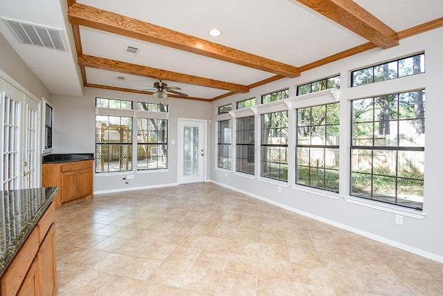 unfurnished sunroom with ceiling fan and beam ceiling