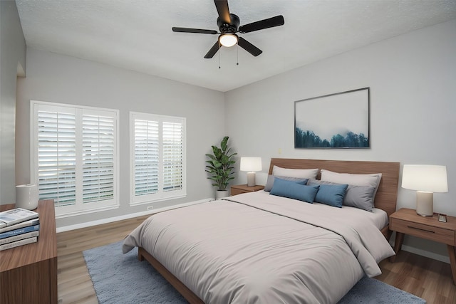 bedroom featuring hardwood / wood-style floors and ceiling fan