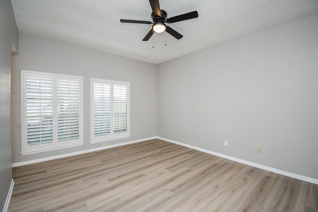 unfurnished room with ceiling fan, light hardwood / wood-style flooring, and a textured ceiling