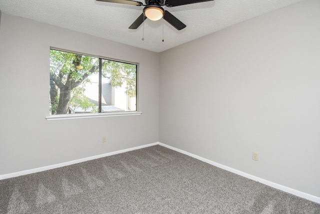 carpeted empty room with ceiling fan and a textured ceiling