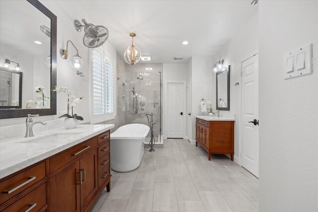 bathroom featuring vanity, shower with separate bathtub, and tile patterned floors