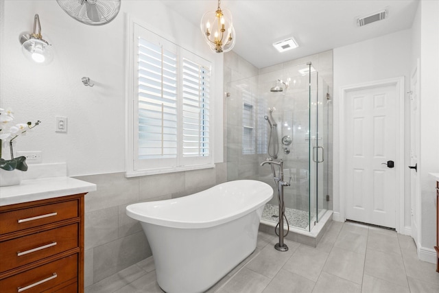 bathroom with tile walls, vanity, a notable chandelier, tile patterned floors, and independent shower and bath