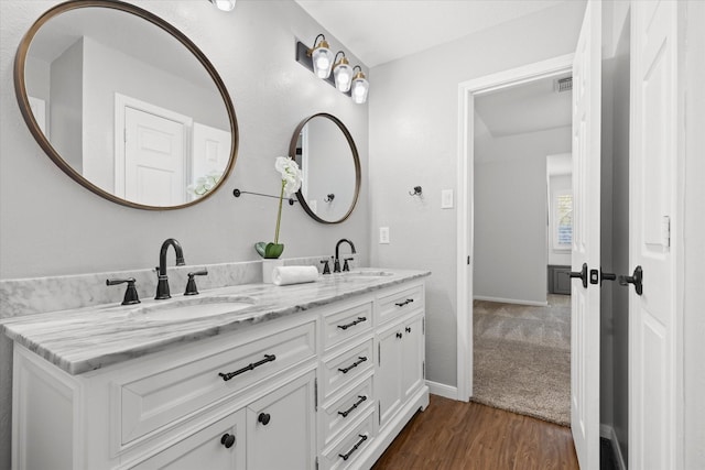 bathroom with vanity and hardwood / wood-style floors