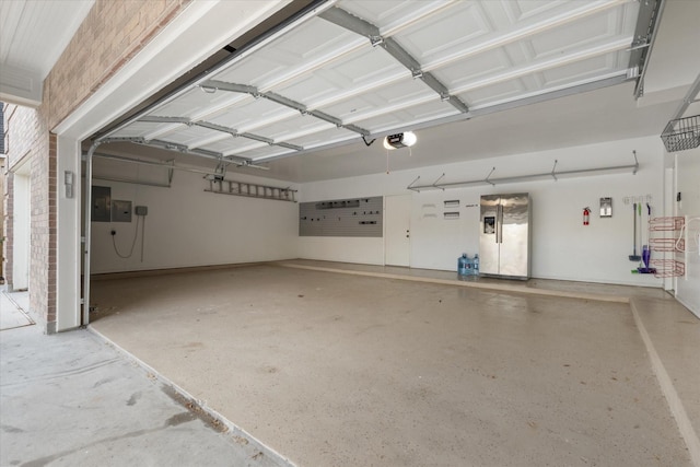 garage with a garage door opener, electric panel, and stainless steel fridge with ice dispenser